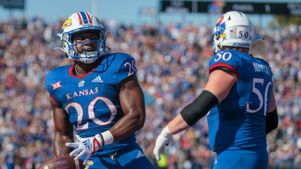 Oct 1, 2022; Lawrence, Kansas, USA; Kansas Jayhawks running back Daniel Hishaw Jr. (20) celebrates in the end zone after a touch down during the second quarter against the Iowa State Cyclones at David Booth Kansas Memorial Stadium. Mandatory Credit: William Purnell-USA TODAY Sports